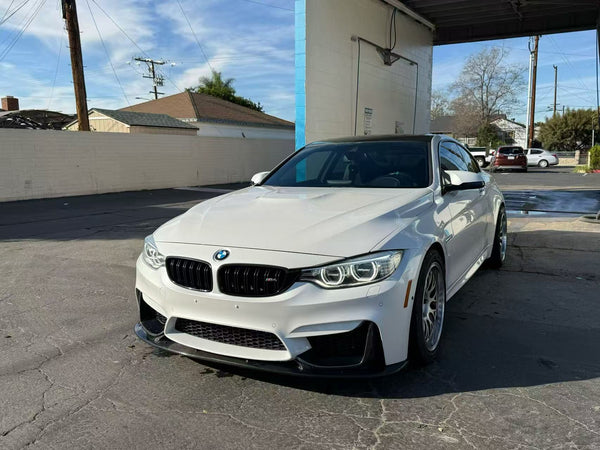 An F82 M4 equipped with our front lip and matching splitters, creating a sharper, more purposeful front profile.